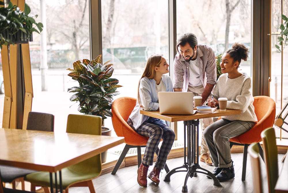 Design is not just what it looks like and feels like. Design is how it works. Concept of presentation new business project. Full-length portrait of three colleagues working together in creative office